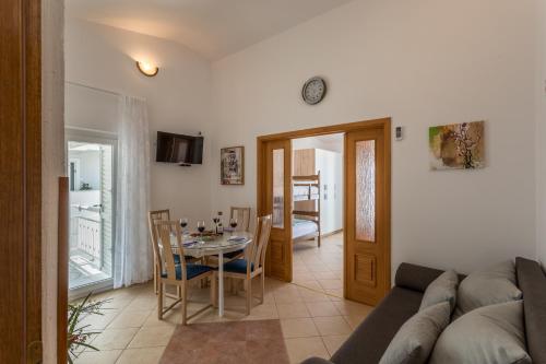 a living room with a couch and a table at Apartments Drago Kovačić in Omiš