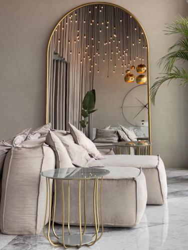 a living room with a couch and a mirror at AG Hotels Antalya in Antalya