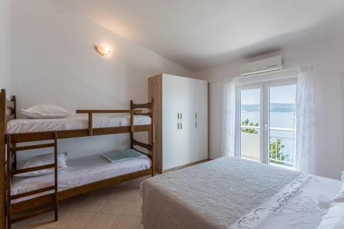Postel nebo postele na pokoji v ubytování Apartments Drago Kovačić