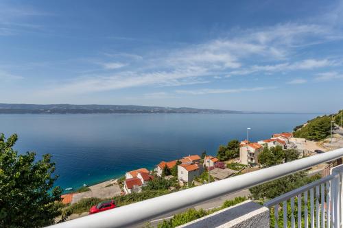 a view of a large body of water from a balcony at Apartments Drago Kovačić in Omiš