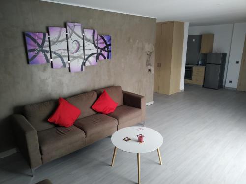 a living room with a couch and a table at Modern Suite, XL balcony, parking in Nicosia