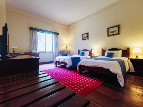 Postel nebo postele na pokoji v ubytování La Mada Hotel