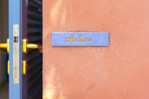 a blue sign that says authentic on a orange door at Casa Giovanni da Procida in Procida