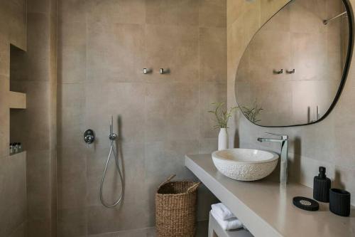 a bathroom with a sink and a mirror at Lourdas White Villa in Kefallonia