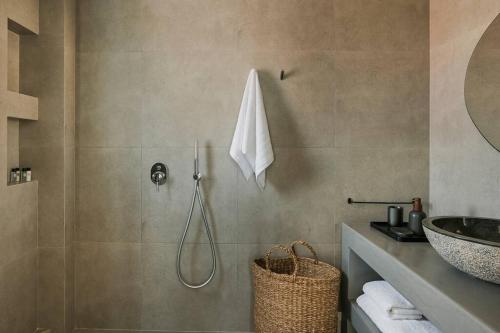 a bathroom with a shower and a sink at Lourdas White Villa in Kefallonia