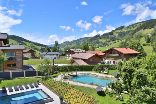 a resort with a swimming pool and some houses at THE MATTHEW - Copper Lodge in Wagrain