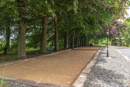 a path in a park with a bunch of trees at Le Domaine de Wisbeley in Halet