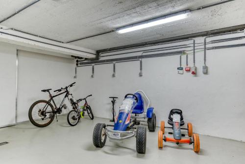 a garage with two bikes and a bike parked in it at Le Domaine de Wisbeley in Halet