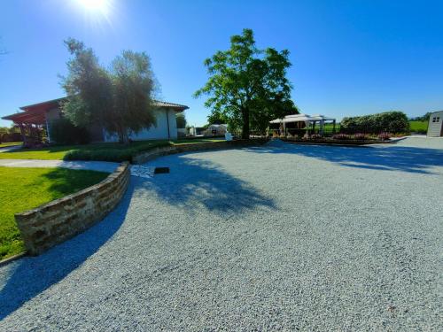 a driveway with a stone wall and a house at B&B Villa Letizia in San Vito Rimini