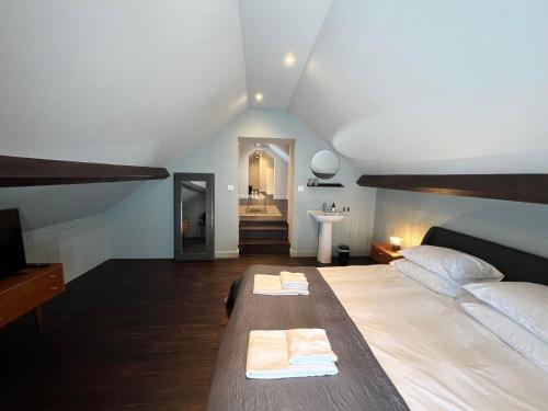a bedroom with a large bed with two towels on it at Le Petit Château in Baye