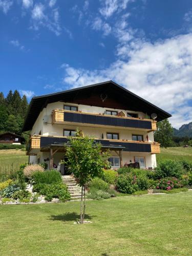a large house with a tree in front of it at Gailtal Panorama in Kötschach