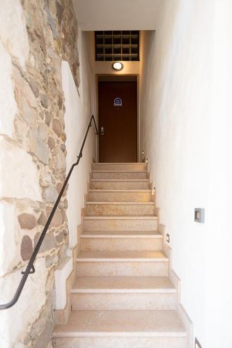 a staircase leading to a door in a building at CASA ROSSA - Regarda Travel in Bardolino