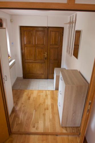 a room with a wooden door and a wooden floor at Villa Anni in Sarajevo