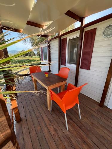 a wooden deck with a table and chairs on a house at Agriturismo Morus Alba Gargano in Foce Varano