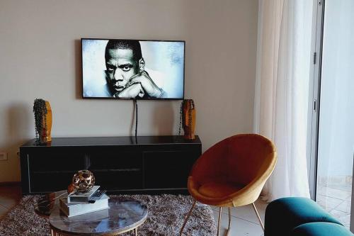 a living room with a flat screen tv on a wall at Queys 401 in Durban