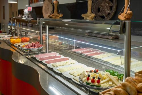 a buffet line with different types of food on display at Ibis Izmir Alsancak in Izmir