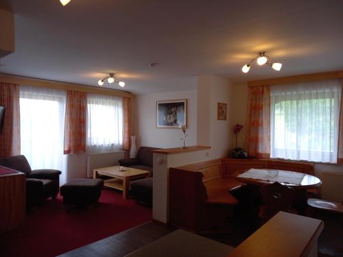 a living room with a couch and a table at Landhaus Wieser in Ramsau am Dachstein