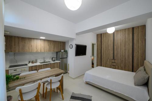 a bedroom with a bed and a table and chairs at Little cozy room by the sea in Messini