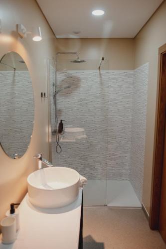 a bathroom with a sink and a shower at Alojamento 88 in Castro Daire