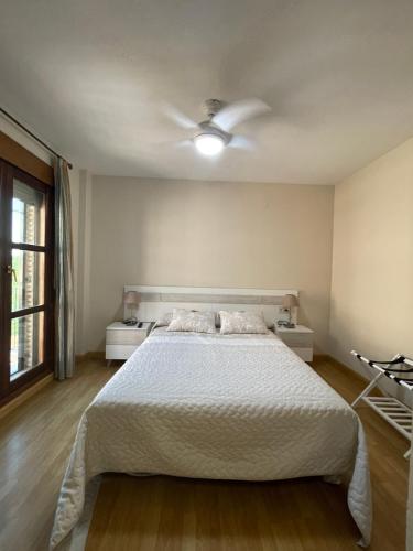 a bedroom with a bed and a ceiling fan at Casa Gallito, By DaiMar in Granada