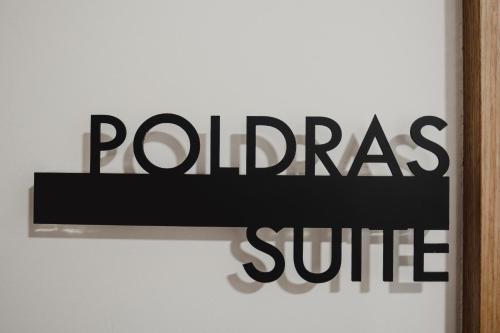 a sign that reads polasire on a white wall at Alojamento 88 in Castro Daire