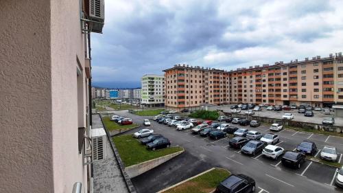 a view of a parking lot with parked cars at Apartman RIM in Lukavica