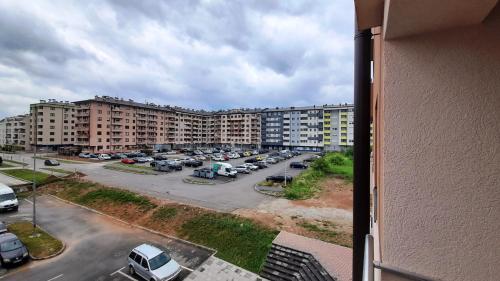 an aerial view of a parking lot with buildings at Apartman RIM in Lukavica