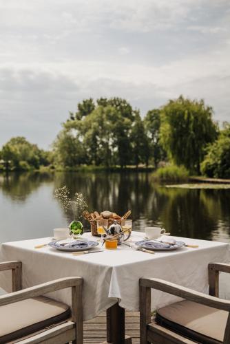 a table with food and a view of a lake at Inn on the Lake in Broek in Waterland