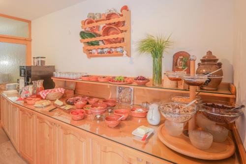 a kitchen counter with lots of bowls and other items at Tourist farm Mulej in Bled