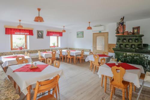 a restaurant with tables and chairs in a room at Tourist farm Mulej in Bled