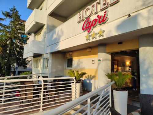 a hotel sign on the side of a building at Hotel Capri in Grado