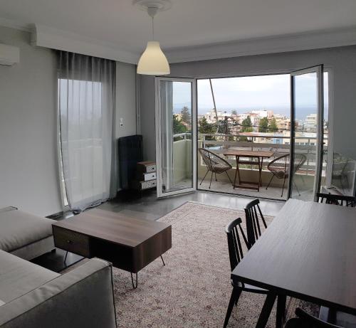 a living room with a couch and a table at Panoramic Apartment in Chios