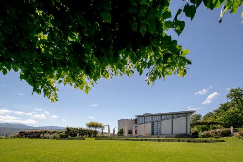 a building in a field with green grass at Roccafiore Wine Resort & Spa in Todi