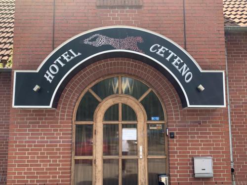 a sign over the door of a brick building at Hotel Ceteno in Wunstorf