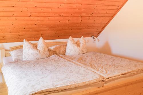 an orange cat laying on a bed in a room at Tourist farm Mulej in Bled