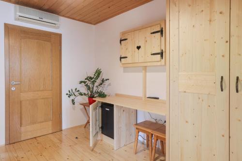 a kitchen with a wooden counter and a door at Tourist farm Mulej in Bled
