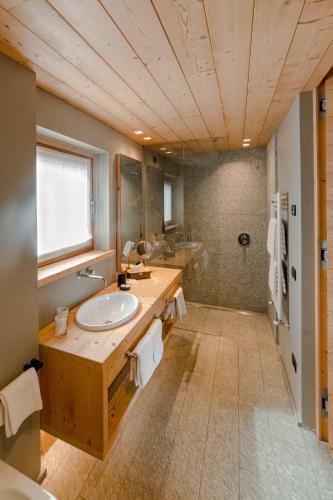 a bathroom with a sink and a shower at Alpi & Golf Hotel in Bormio
