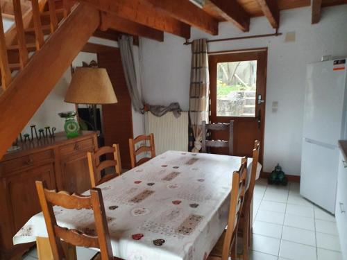 a kitchen with a table with a white table cloth on it at Gite des 3 Cailloux in Leulinghen-Bernes