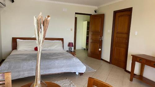 a bedroom with a large bed with a wooden headboard at Lagun Ocean View Villa with Own Private Beach in Willemstad
