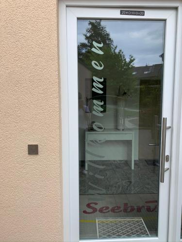 a glass door with a sign that says sea cleaners at Seebrise mit Musik und Wein in Meersburg