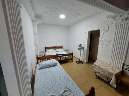 a room with two beds and a lamp in it at Villa Kasa in Durrës
