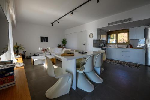 a kitchen and a living room with a table and chairs at 5 meters from the beach in Chrani