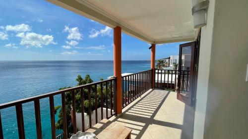 a balcony with a view of the ocean at Lagun Ocean View Villa with Own Private Beach in Willemstad