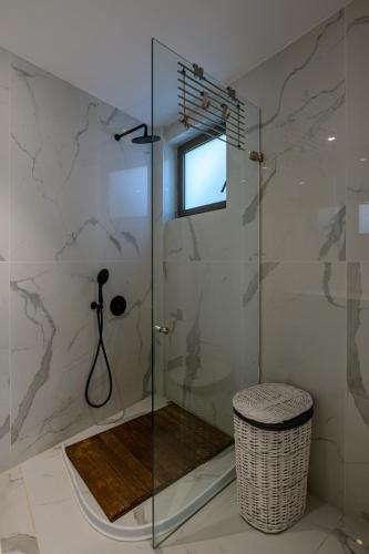 a shower with a glass door in a bathroom at 5 meters from the beach in Chrani