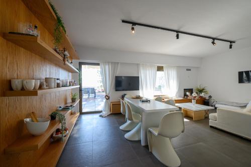 a living room with a white table and chairs at 5 meters from the beach in Chrani