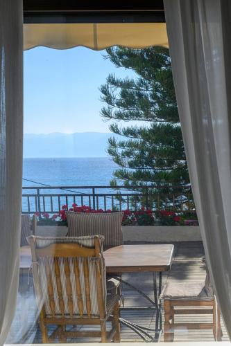 a patio with a table and chairs and the ocean at 5 meters from the beach in Chrani