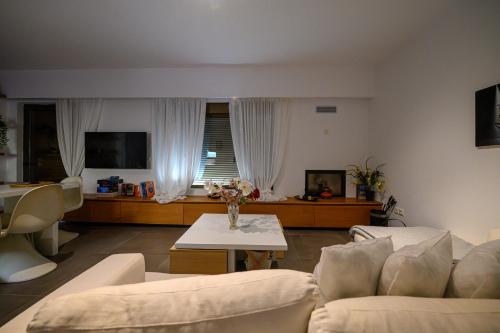 a living room with a couch and a table at 5 meters from the beach in Chrani