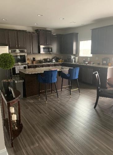 a kitchen with blue chairs and an island in it at Private, quiet, immaculate bachelor pad with free parking on site in Decatur