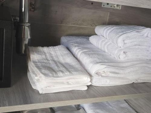 a group of white towels sitting on a shelf at Tropical Suite in Diamante