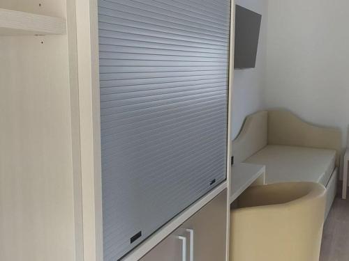 a closet with a sliding glass door in a kitchen at Tropical Suite in Diamante